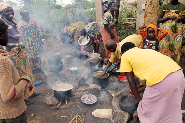 Women supplement their meager cooking and children in search of wild vegetables because distributed ration is not only insufficient and inadequate. Photo by Caritas Rwanda