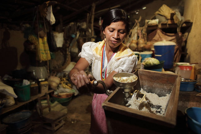 Woman making flour in Guatemala. Photo by Caritas