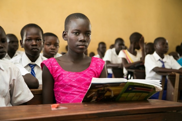 Even before the resurgence of violence in South Sudan in July-August 2016, CRS had been aiming to improve education in South Sudan with a pilot project in Juba focusing on three Catholic schools. The work included teacher training, since most teachers lacked many basic skills, provision of school supplies such as textbooks and notebooks, and rehabilitation of latrines and clean water provision, which can improve school enrollments. In South Sudan, only 10 percent of children complete Primary school. In July/August 2016, the water and sanitation work took on added importance. However, fatal outbreaks of cholera broke out, especially in Juba due to large-scale displacements which resulted in huge numbers of people living in unsanitary camp conditions. Some 5000 cases have been reported with over 100 fatalities, and the outbreak has not yet been brought under control. CRS, with funding from Latter-day Saints Charities worth $350,000, carried out the rehabilitation of disused boreholes and built new ones, cleaned out pit latrines and refurbished them, built new blocks of latrines, set up multiple hand-washing stations and established school health clubs to share hygiene messaging, not just in school but to entire families and communities when the children are at home. A student at St. Kizito's Primary School.