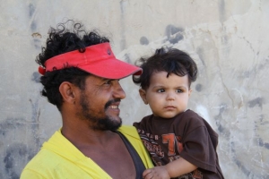 A Palestinian father holds his son in Gaza. Liz O'Neil/CRS