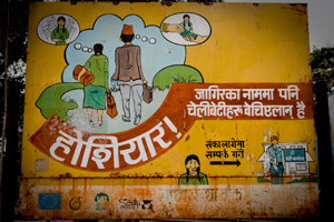 At the border of Nepal and India, a sign warns young women that a man who offers them a job in another city may actually intend to sell them. At some borders, women who were former trafficking victims are now guards who monitor suspicious activities and try to protect young women. Credit: Katie Orlinsky/Caritas