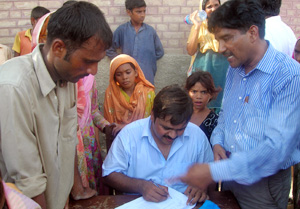 Ameen Babar monitoring the issuance of slips to recipients. Credits: Caritas Pakistan
