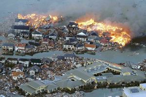 Houses swept out to sea burn following a tsunami and earthquake in Natori City in northeastern Japan March 11, 2011. The biggest earthquake to hit Japan since records began 140 years ago struck the northeast coast on Friday, triggering a 10-metre tsunami that swept away everything in its path, including houses, ships, cars and farm buildings on fire. Credits: YOMIURI/REUTERS/Alertnet.org