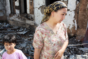 In mid-June 2010, violence broke out in the south of Kyrgyzstan. Many Uzbek homes were burned, people were killed, and thousands of people fled to the border between Kyrgyzstan and Uzbekistan. Some Uzbeks have since returned to their burned-out homes and are living in their yards or porch areas. Others are staying with Uzbek friends in houses away from the city. As of June 23, Catholic Relief Services is assessing needs in Osh and Jalalabad. Credits: Laura Sheahen/Catholic Relief Services