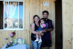 Caritas beneficiaries in front of their new home built by Caritas Credits: Caritas Chile