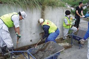 Caritas Japan volunteers from Yonekawa base working on debris removal. Credits: Caritas Japan