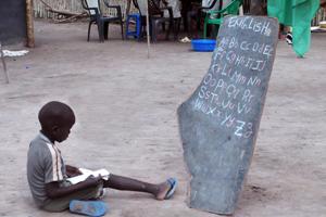 A child is learning English through a homeschool in Rumbek, South of Sudan Credits: Limburger/Caritas Austria