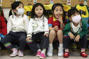 Kindergarten students wear masks while attending a lesson in Hong Kong April 30, 2009. The World Health Organization said on Wednesday the world is at the brink of a pandemic, raising its threat level as the swine flu virus spread and killed the first person outside of Mexico, a toddler in Texas. Credits: REUTERS/Tyrone Siu (CHINA EDUCATION HEALTH)