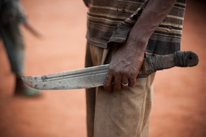 A man holds a machete (aka Balaka in Songo) on November 8, 2013 in the outskirts of Bangui. Chaos followed the ouster of Francois Bozize earlier this year, opposing the anti-Balaka and the ex-Seleka rebels and reports of summary executions, looting and abuses against civilians have prompted international concern that the Central African Republic could become another Somali-style failed state. Credit: Matthieu Alexandre/Caritas