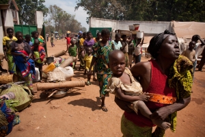 Internally Displaced Persons (IDP's) arrive to take shelter next to the Cathedral on November 10, 2013 in Bossangoa, 380 km north of Bangui. Credit: Matthieu Alexandre