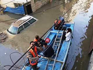 Despite the floods Caritas Jerusalem’s medical team took boats, grabbed ladders and assisted many stranded families with medicines, first aid and food. Credit: Caritas Jerusalem