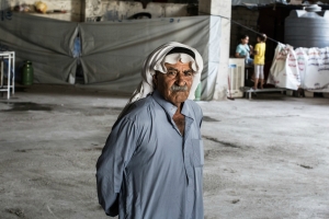 An internally displaced Christian man in the construction site in Erbil, Iraq where he has found shelter. Caritas has been supporting Christian and Yazidi families forced to flee. Photo by Daniel Etter for Catholic Relief Services