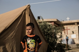 An internally displaced Christian boy seen on the grounds of St. Eliyah Church, Ainkawa, Erbil, Iraq, where Caritas Iraq works. Photo by Daniel Etter for Catholic Relief Services