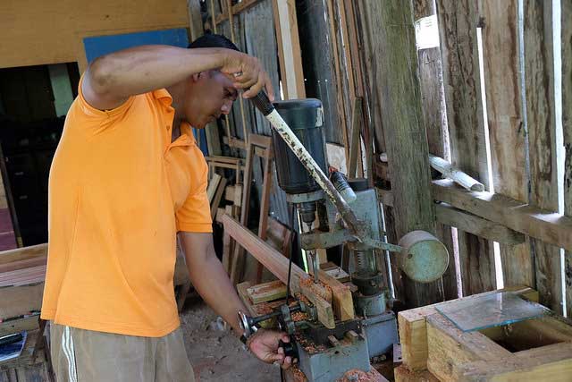 Matakin in his carpentry workshop next to his house, built by CRS. 