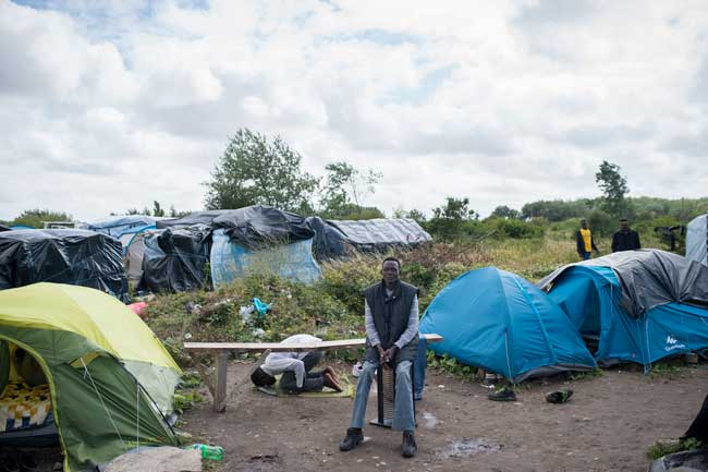 Refugees camp in Calais waiting to continue their journey into England. 
