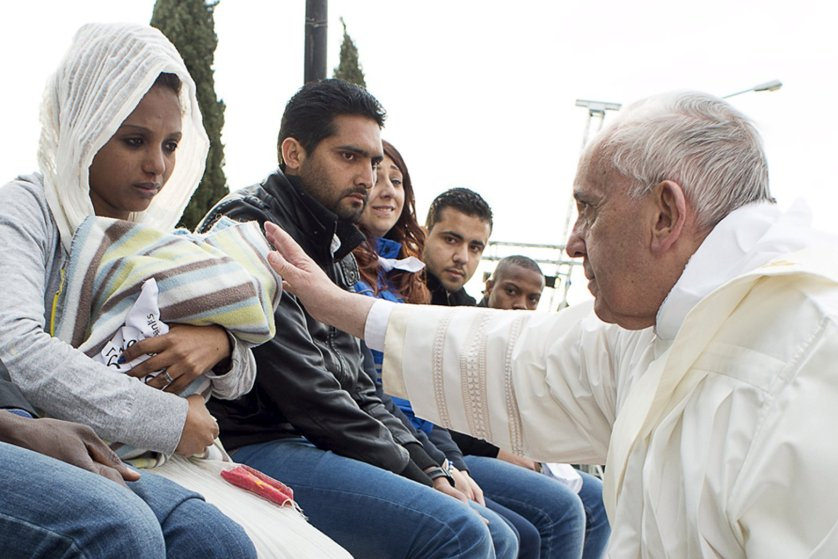 Pope Francis blesses a baby during the foot-washing ritual