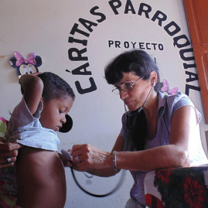 A child in Venezuela is seen by a health worker