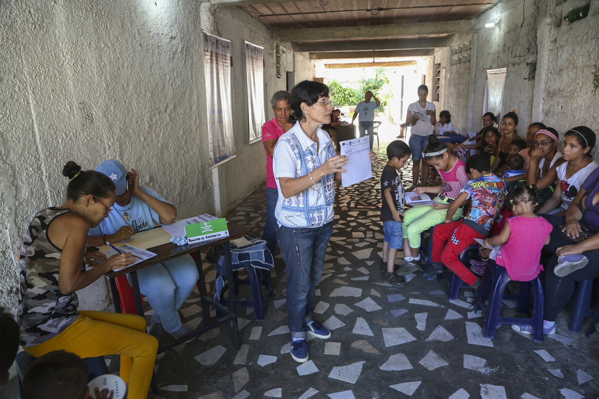 Caritas Venezuela volunteer Dr. Albina Rosas leads caregivers in a nutrition session and how to protect their children from disease. Children already vulnerable due to under-nutrition have a harder time fending off disease.