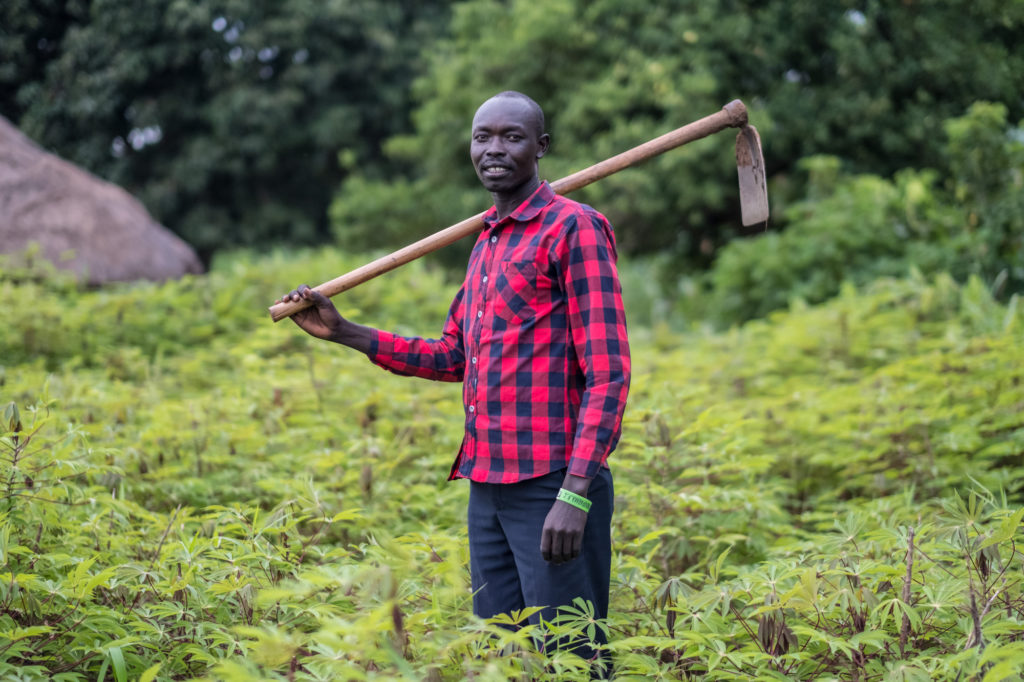 Youssef Gule, a Ugandan farmer who lives nearby to Bidi Bidi refugee settlement, photographed in a cassava field.