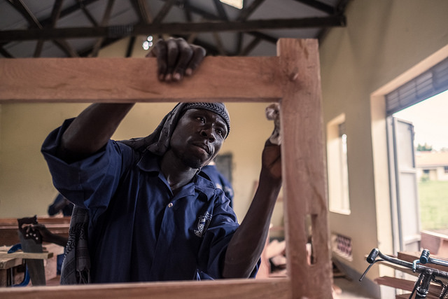 Refugees and members of the local community work together in a carpentry workshop at a techincal college supported by Caritas in Yumbe, Uganda.