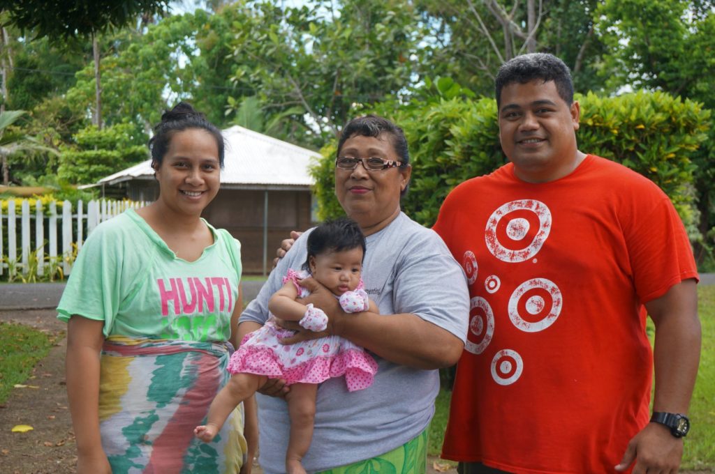 Malia Masoe (centre) and her family experience frequent flooding in their home. Photo: Caritas