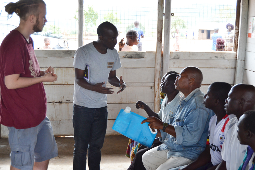 Alexander from solarsack helps train people in Uganda in how to use the solar powered water filter.