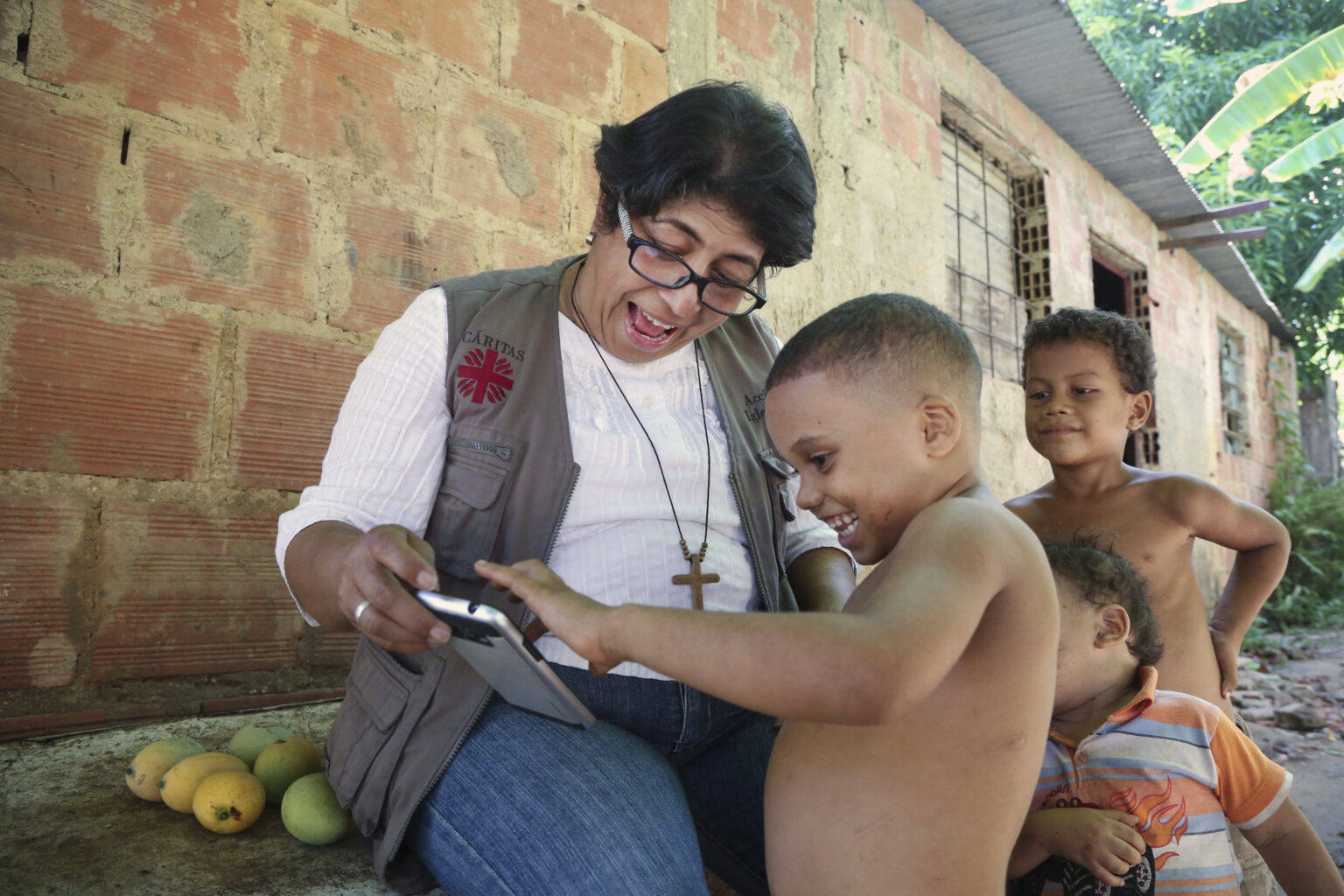 Sister Maria José of Caritas Los Teques plays with Yonaikel, 5. His two younger siblings are currently receiving nutritional support from Caritas due to undernutrition. The current minimum monthly salary averages to about $1.50 and covers only 2 percent of the minimum nutritional basket. As of March 2018, it would require 73 monthly salaries solely to cover the cost of feeding a family. Families cope by selling off goods, cutting back on meals and the quantity of food served at each meal. Routine growth monitoring sessions conducted by Caritas has shown that 70 percent of children under 5 show signs of some form of nutrition with 8 percent from severe malnutrition. Galloping inflation has pushed 92 percent of the population into poverty. The current minimum monthly salary averages to about $1.50 and covers only 2 percent of the minimum nutritional basket. As of March 2018, it would require 73 monthly salaries solely to cover the cost of feeding a family. Families cope by selling off goods, cutting back on meals and the quantity of food served at each meal. Routine growth monitoring sessions conducted by Caritas has shown that 70 percent of children under 5 show signs of some form of nutrition with 8 percent from severe malnutrition.